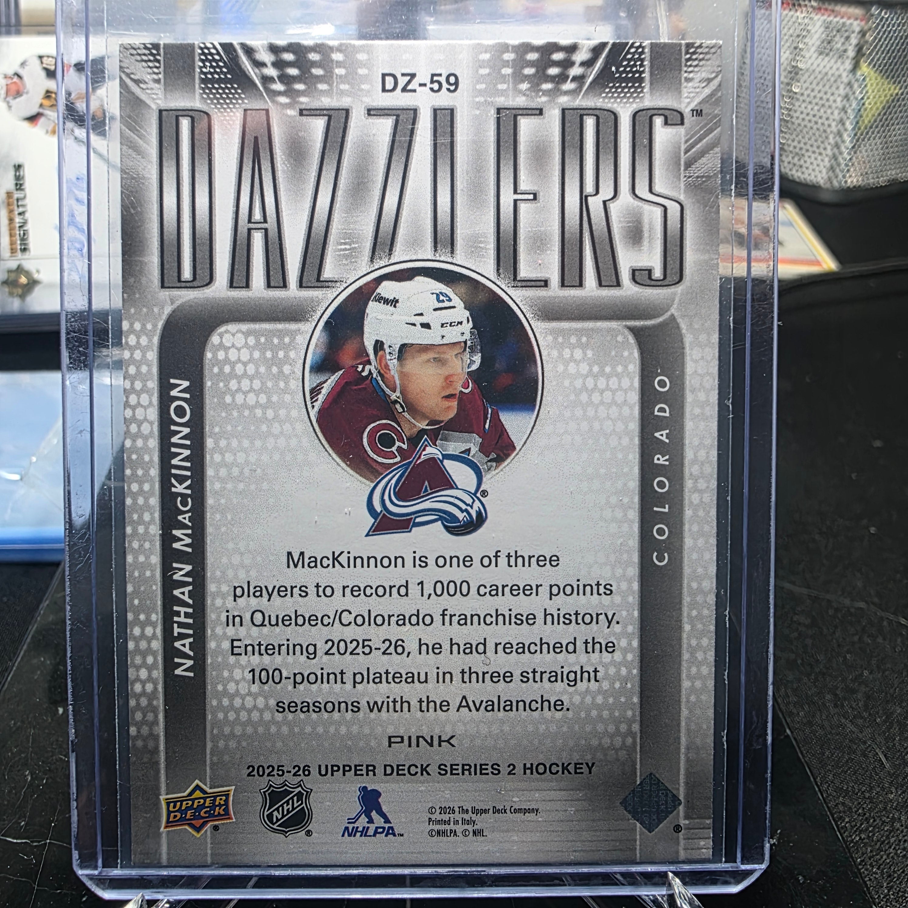 2025-26 Upper Deck Series 2 Nathan MacKinnon Dazzlers Pink #DZ-59 (Colorado Avalanche)