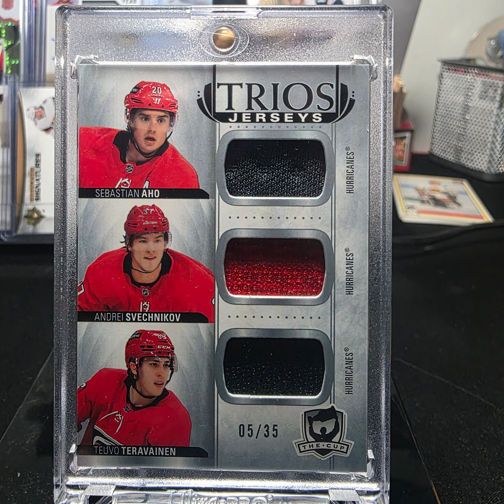 2021-22 The Cup Hockey Trios Jerseys Sebastian Aho / Andrei Svechnikov / Teuvo Teravainen Patch #05/35 (Carolina Hurricanes)